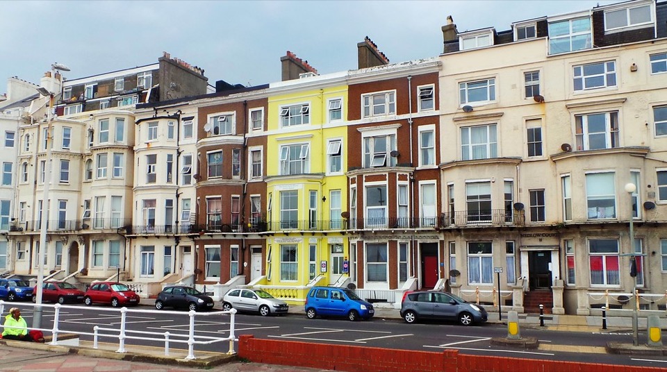 A row of colourfully painted seafront terrace houses in Hastings, East Sussex
